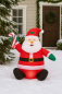 Preview: Aufblasbarer Weihnachtsmann mit LED – 122 cm – Sitzende Santa-Deko mit Zuckerstange für Garten & Haus