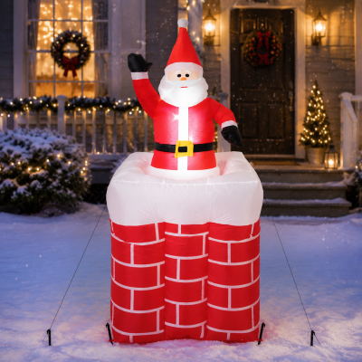 Selbstaufblasender LED-Nikolaus im Schornstein in einem weihnachtlich dekorierten Vorgarten